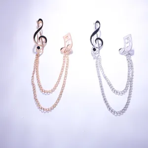 Detailed view of the elegant musical note chain brooch, showcasing fine metallic links and dual.