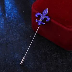 Detail shot of the metal fleur-de-lis lapel pin with sparkling blue rhinestones for men suits.