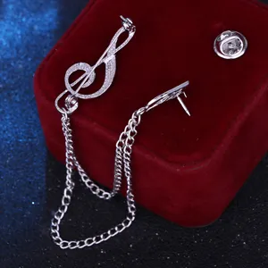 Silver treble clef brooch with chain tassels, elegant lapel pin for suits and shirts.
