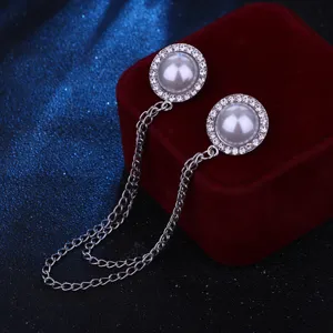Close-up detail of a Korean style pearl rhinestone chain collar pin and shirt brooch accessory.