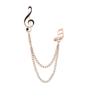 Rose gold music note brooch with double chain tassel, elegant lapel pin for suits and shirts.
