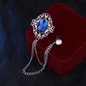 Retro court style hollow blue gem brooch with silver tassel chain for men suit detail.