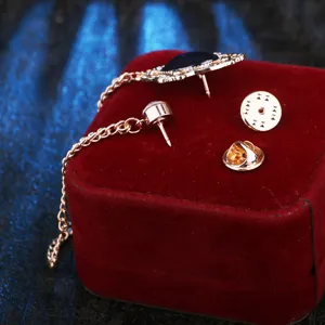 Retro court style hollow gemstone brooch with chain, elegant men's suit lapel pin accessory.
