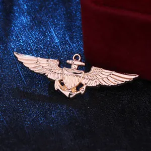Detailed close-up of rose gold military pilot wings badge, perfect for uniform or jacket decor.