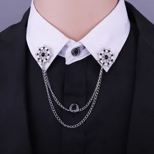Close-up detail of double ship wheel collar pin with layered chains, fashion decor.