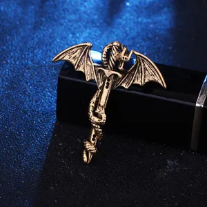 Close-up detail of retro vintage bronze dragon sword brooch pin with wings and snake design.