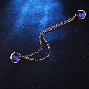 Detail view of the stylish rose gold shirt collar chain featuring sparkling dark blue gems.