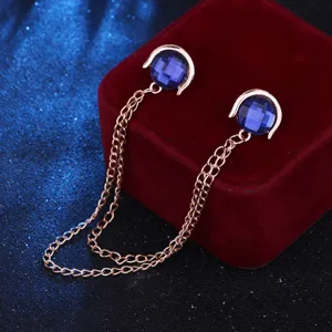 Close-up detail of the elegant blue crystal shirt collar chain with rose gold tone metal.