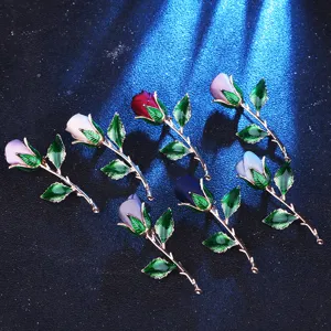 Rose flower brooch pin set with metal stem and fabric petals for women dress accessories.