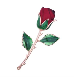 Elegant fabric rose brooch with enameled green leaves and rose gold stem for evening dresses.