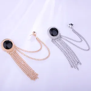 Detailed view of fashionable metal tassel suit brooch with black stone for men and women apparel.