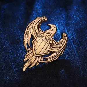 Retro golden eagle shield brooch detail shot showing vintage metallic texture and craft.