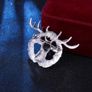 Back detail view of vintage elk head alloy brooch pin, secure clasp mechanism shown clearly.