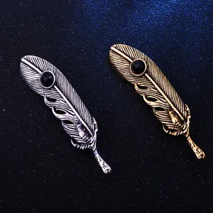 Detailed view of retro vintage eagle claw feather brooch with black crystal stone, alloy metal.