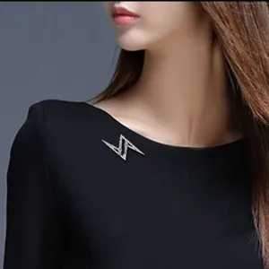 Detailed shot of a stylish lightning shape rhinestone brooch pin for men and women suits.