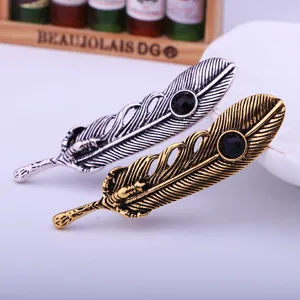 Retro feather brooch detailed view showing eagle claw design and black stone inlay options.