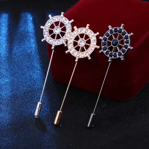 Detailed close-up view of nautical ship wheel stick pins featuring sparkling crystals for men suits.