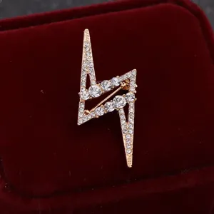 Detailed shot of a stylish lightning rhinestone brooch, sparkling crystal suit pin accessory.