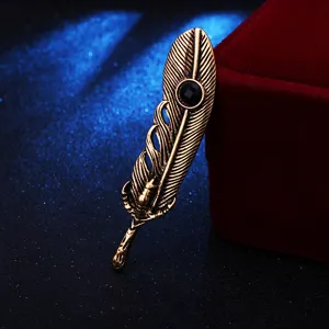 Close-up detail of vintage retro feather brooch with black crystal and eagle claw accent.