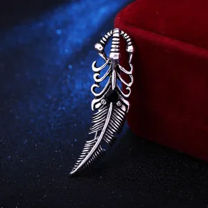 Vintage hollow silver feather brooch for men, detailed gothic style lapel pin accessory.