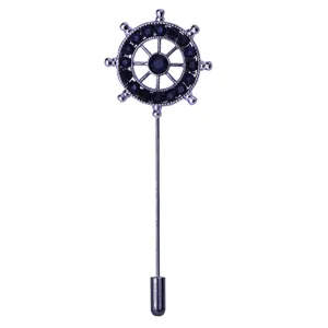 Details of the nautical ship helm stick pin, featuring dark blue rhinestone inlay on silver-tone metal.