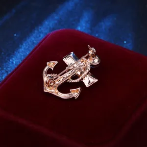 Detailed view showing the secure pin mechanism on the back of a rose gold anchor brooch.