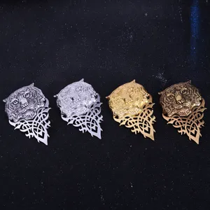 Detailed view of vintage tiger head brooches in four metallic finishes with ornate filigree.