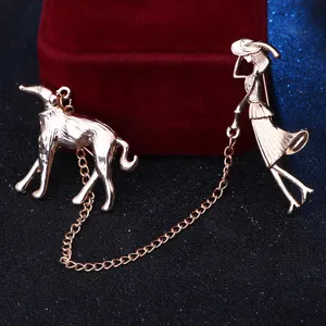 Gold tone lady walking dog brooch pin, elegant animal jewelry accessory for coat lapel.