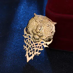 Gold tiger head brooch with intricate filigree details, perfect for men's suits and blazers.