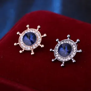 Exquisite nautical helm brooch detail showing alloy metal luster, blue crystal and clear rhinestones.
