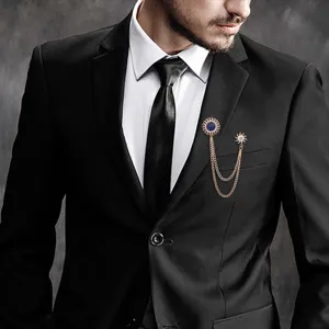 Detail view of vintage style mens metal tassel brooch for suit lapel and collar pin.