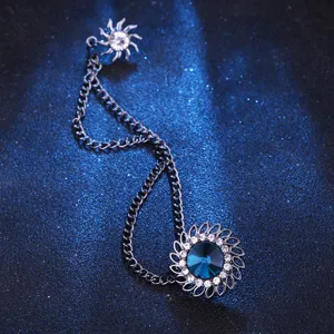 Vintage court style blue crystal brooch with tassel chain, perfect suit lapel accessory detail.