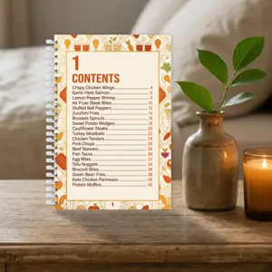 Detail shot of a recipe notebook index page featuring food titles on a wooden cozy table.