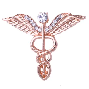 Broche épingle ailes d'ange strass or rose symbole médical caducée accessoire bijoux tendance