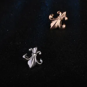 Retro gothic style metal fleur-de-lis brooch pins set in silver and rose gold finishes.