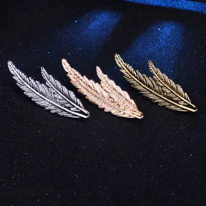 Vintage feather brooch pin for men and women, elegant leaf shape suit jacket accessory detail shot.