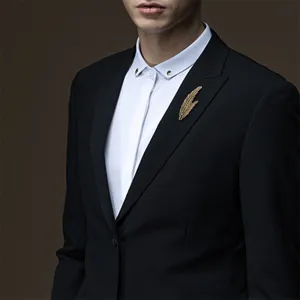 Detailed shot of retro feather brooch, elegant leaf shape pin for men and women suits.