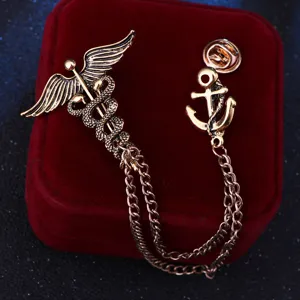Vintage caduceus and anchor brooch detail view, antique gold finish with delicate double chains.