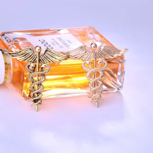 Detailed shot of retro angel wings snake brooch, exquisite metal alloy pin fashion accessory.