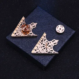 Detail shot of retro gold triangular filigree collar pin, exquisite hollow carved metal brooch.