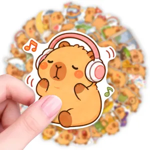Detailed view of cute capybara sticker wearing pink headphones, perfect for journal decor.