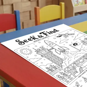 Detailed view of children rocket launch theme coloring poster on colorful desk, fun art activity.