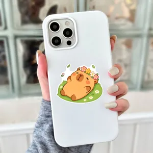 White silicone phone case featuring a cute cartoon capybara lying on grass, soft cover.