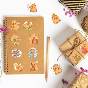 Close-up detail shot of cute cartoon capybara stickers, waterproof notebook journal decoration.