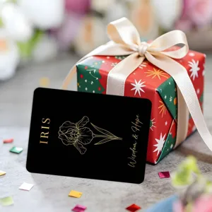 Exquisite black botanical greeting card featuring metallic gold iris design with gift box.