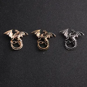 Close-up details of retro dragon brooches in gold, bronze and silver finish styles.