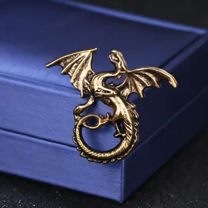 Vintage gold dragon brooch pin, retro fantasy animal corsage shawl scarf jewelry accessory.