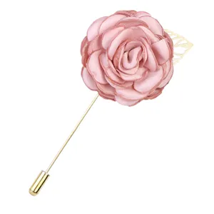 Elegant pink fabric camellia flower brooch with gold long pin and leaf accent for women.