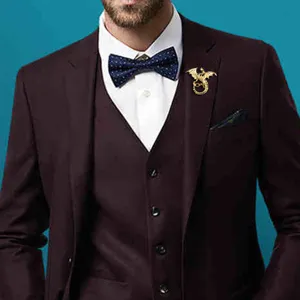 Detail shot of a vintage gold dragon brooch pinned on a stylish men's suit lapel elegantly.