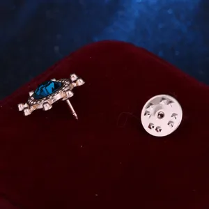 Detailed view of the blue rhinestone helm brooch pin back and clutch closure showing quality.